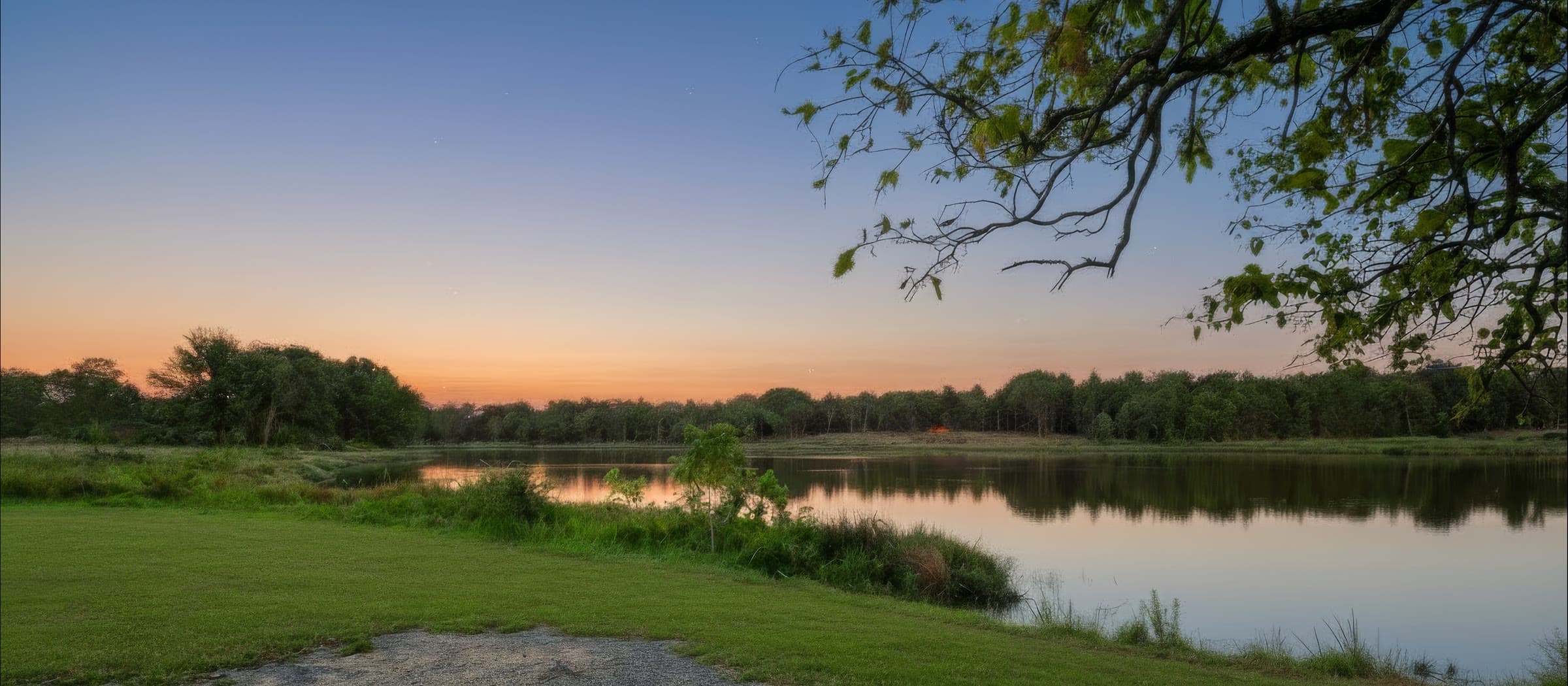 A wide view across the 14-acre lake at Bloom Estates at dusk